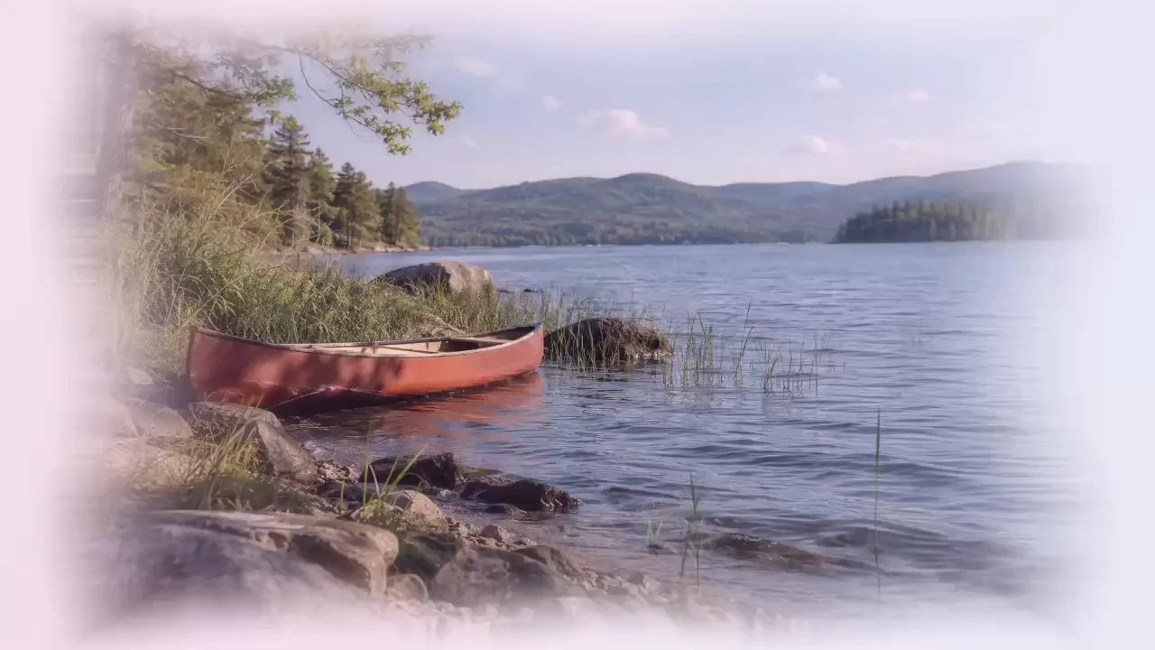 A red canoe on a lake, a faded film memory in Iris Loop
